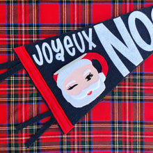Load image into Gallery viewer, Closeup of the winking Santa mug on the pennant