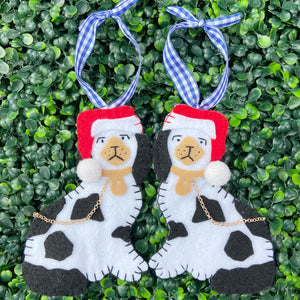 Pair of Staffordshire dog ornaments wearing red santa hats.