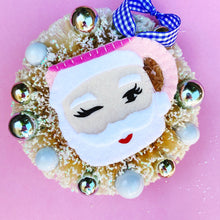 Load image into Gallery viewer, Closeup of Winking Santa Ornament in Pink
